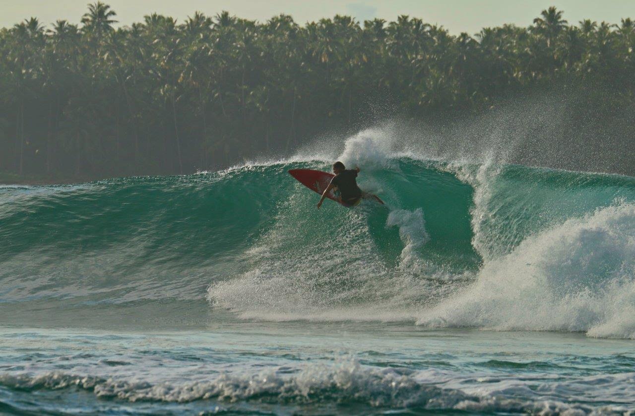 Surfing a glassy teal wave